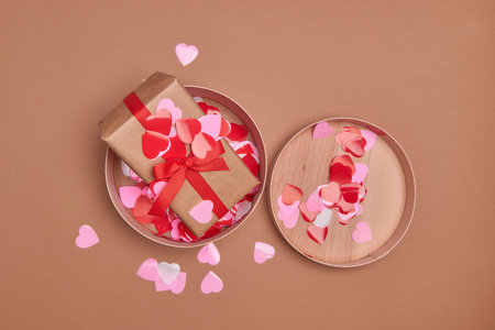 Valentine day composition. Giftbox, confetti, envelope postcard with red heart on pastel backgroundの写真素材