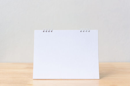 Mockup blank desk calendar on wood table. Template for designの写真素材