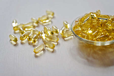 Fish oil pills. Omega-3 gel capsules. Food supplement obtained from cod liver. Healthcare and medical concept.の写真素材