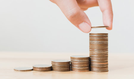 Saving money and investing is growing growth wealthy and sustainable for the future concept, Hand of male or female putting coin stack step growing growth financialの写真素材