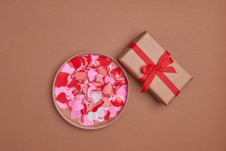 Valentine day composition. Giftbox, confetti, envelope postcard with red heart on pastel backgroundの写真素材