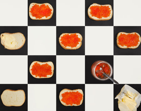 Salmon caviar canapes, butter, red caviar in a jar on chess board, top viewの写真素材
