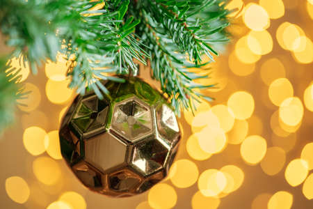 Christmas tree background with golden bauble on bokeh sparklingの写真素材