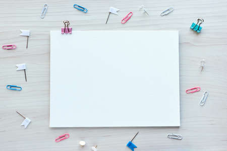 School office supplies on wooden background. Back to school concept. White board with hands for copy space. Top view ready for your designの写真素材