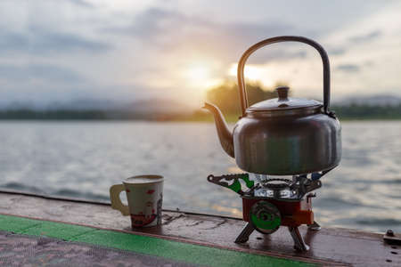Coffee time and slow life on morning time sunrise kettle and cup .の写真素材