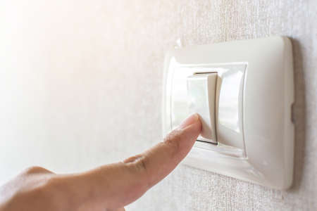 Concept save energy. Hand turning off switchの写真素材