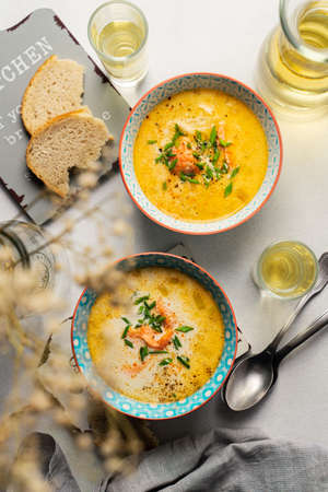 Homemade Finnish salmon soup with cream served with white wineの写真素材