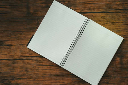 Notebook on brown wood floorの写真素材