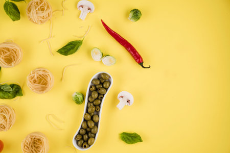 Pasta, basil, olives. Background of products. Top view. Copy space on the right.