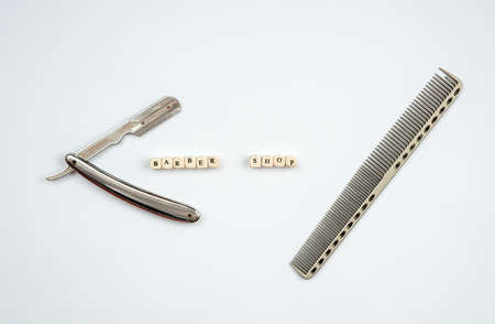 Razor and comb on a white background. Barber tool close-up.の写真素材