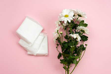 Feminine gasket for menstruation and white flower on a pink background.の写真素材