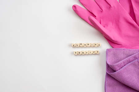 Cleaning set for different surfaces in the kitchen, bathroom and other rooms. Empty place for text or logo on blue background. Cleaning service concept. Top view.Flat layの写真素材