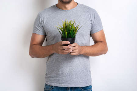 Cropping image - Man with fresh grass pot in his hands .Concept World Environment Dayの写真素材