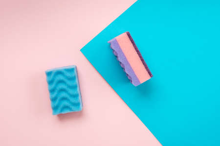 Multicolored kitchen washcloths laid on a pink and blue backgroundの写真素材