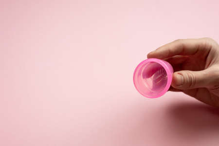Close-up of young woman hands folding a menstrual cup.の写真素材
