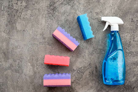 Spray and sponges on a gray background.の写真素材