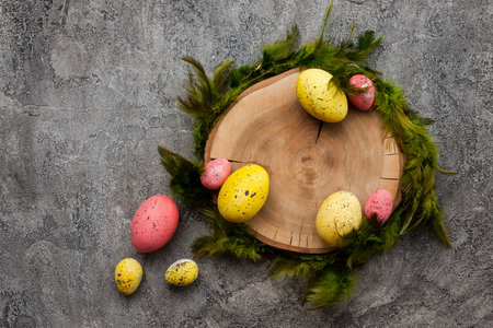 Colorful, easter eggs around wooden stand on pink backgroundの写真素材