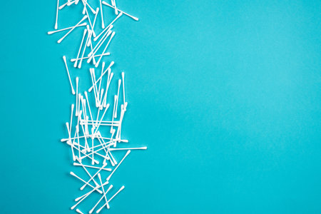 Cotton ear sticks on blue background. Cotton ear sticks isolated on blue background