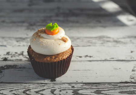 a view of a cupcake on a white wooden table