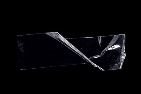 adhesive transparent tape on black background