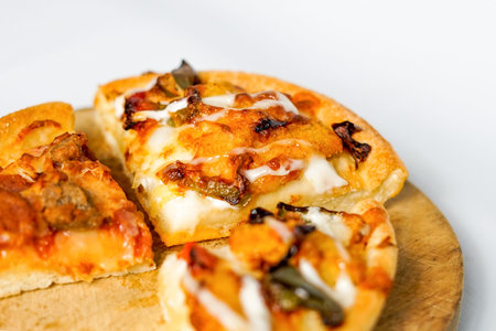 some slices of pizza on the wooden paddle