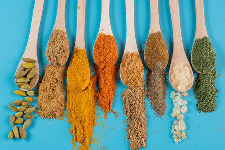 colorful spices in spoonsの写真素材