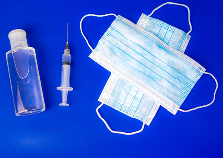 blue background with a syringe a bottle
