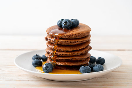chocolate pancake stack with blueberry and honeyの写真素材