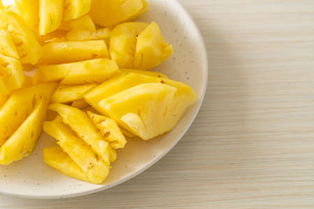 fresh pineapple sliced on plateの写真素材