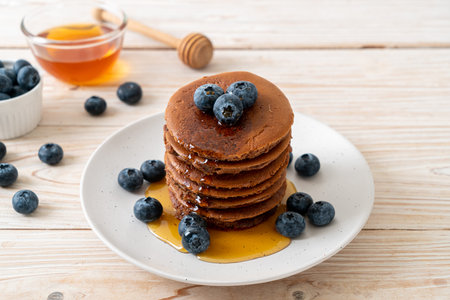 chocolate pancake stack with blueberry and honey
