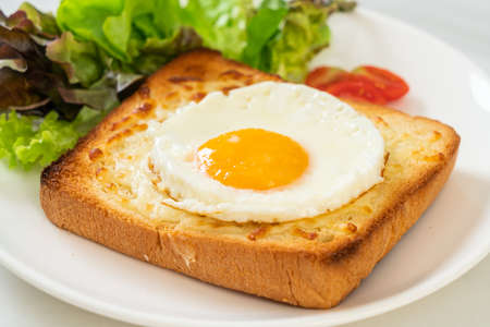 bread toasted with cheese and fried eggの写真素材