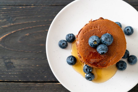 chocolate pancake stack with blueberry and honey