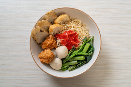 egg noodles with fish balls and shrimp balls in pink sauce, Yen Ta Four or Yen Ta Foの写真素材