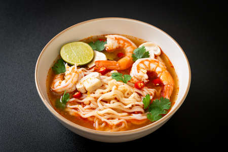 instant noodles ramen in spicy soup with shrimps (Tom Yum Kung)の写真素材