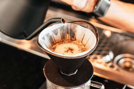 pouring hot water for dripping coffeeの写真素材