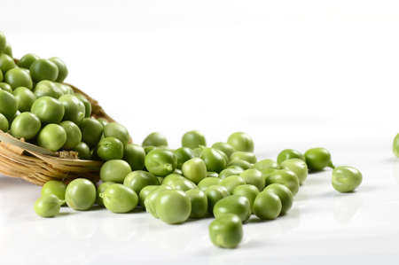 Fresh Green Peas in basket on white backgroundの写真素材