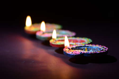 Clay diya lamps lit during diwali celebration. Greetings Card Design Indian Hindu Light Festival called Diwaliの写真素材