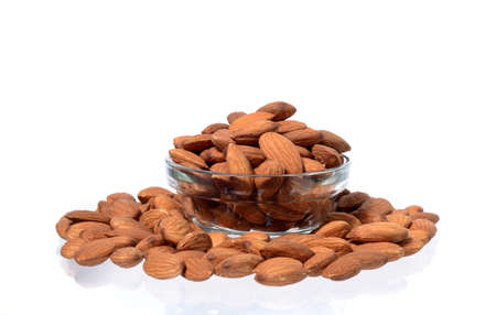Almonds in a bowl isolated on a white backgroundの写真素材