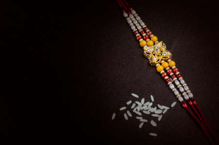 Raksha Bandhan background with an elegant Rakhi. A traditional Indian wrist band.の写真素材
