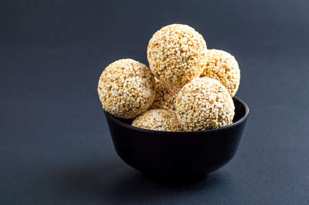 Amaranth or Rajgira laddu, Cholai ke laddo in black Bowl on black backgroundの写真素材