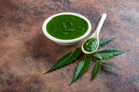 Medicinal Neem leaves with paste on stone backgroundの写真素材