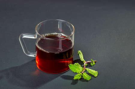 Cup of tea, mint and lemon on dark backgroundの写真素材