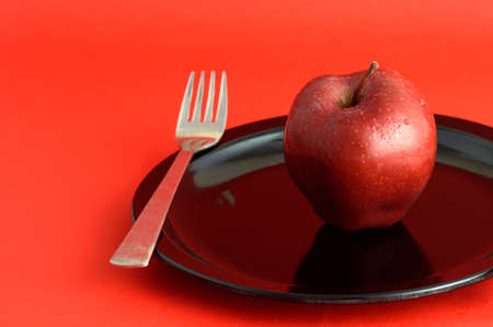 Ripe Red Apples on red backgroundの写真素材