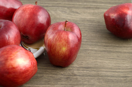 Ripe red apples on wooden background