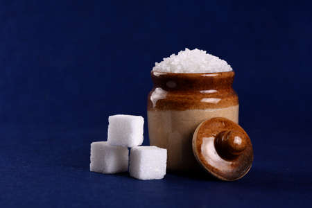 Sugar. white granulated sugar and refined sugar on a blue backgroundの写真素材