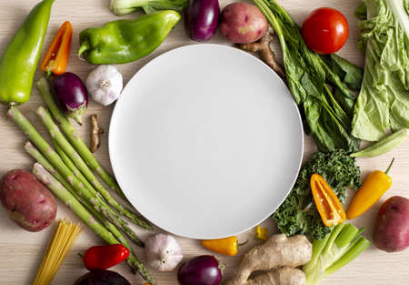 top view assortment veggies with empty plate. High quality and resolution beautiful photo conceptの写真素材