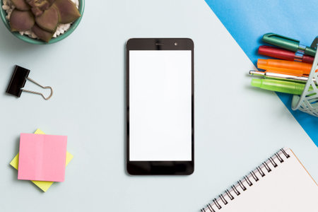 smartphone surrounded by office supplies. High quality and resolution beautiful photo concept