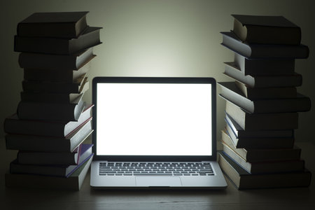laptop dark stacked books. High quality and resolution beautiful photo conceptの写真素材