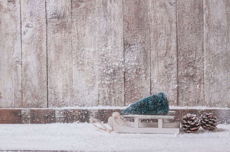 wooden wall with small sleigh with christmas tree. High quality and resolution beautiful photo conceptの写真素材