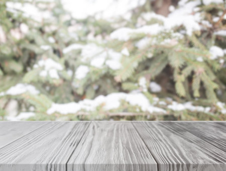 empty wooden table front christmas tree with snow. High quality and resolution beautiful photo...